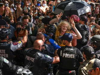 Protesters block police vehicles from leaving the University of Texas at Austin on Monday, April 29, 2024